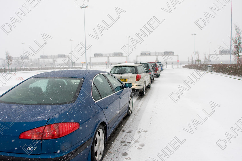 90313 RoadSnow 
 Cars queue under snow for Channel Tunnel Calais 
 Keywords: road snow channel tunnel motorway calais travel winter