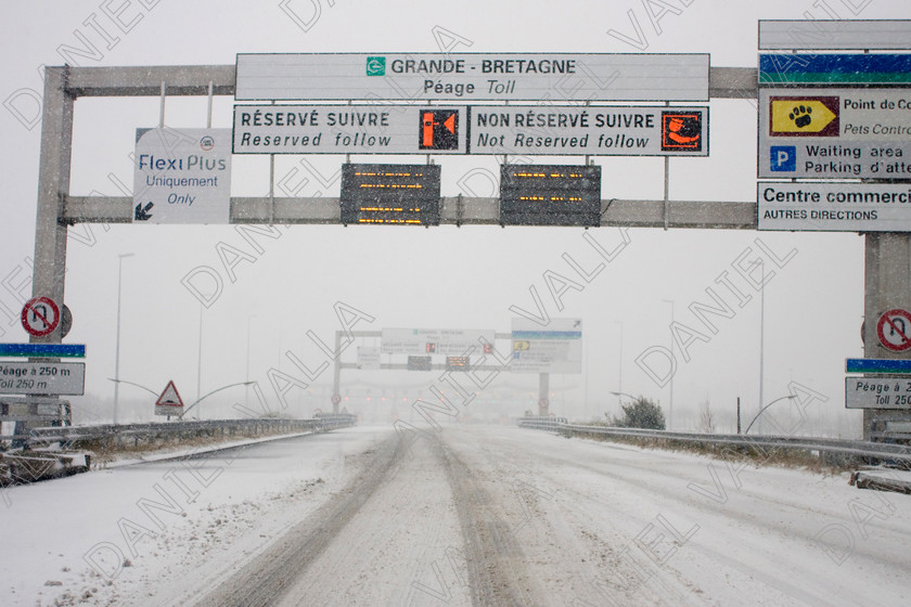 90295 RoadSnow 
 Snow over Motorway approach to Channel Tunnel Calais 
 Keywords: road snow channel tunnel motorway travel winter